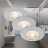 Three white recessed ceiling lights are shown in a bathroom setting, with a toilet and shower visible in the background. Produktbild-Vorschau