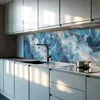 A modern kitchen with a marble-patterned backsplash and sleek cabinets. Podgląd zdjęcia produktu