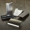 Several door handles of different colors and finishes are arranged on a textured surface. Produktbild-Vorschau