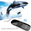 A remote control is shown in the foreground with a television screen displaying orcas jumping out of the water in the background. Podgląd zdjęcia produktu