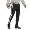 A person wearing Adidas Squadra 21 training pants and holding a soccer ball. Produktbild-Vorschau
