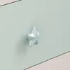 A close-up of a light blue starfish-shaped drawer knob on a light green surface. Anteprima dell’immagine prodotto