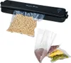 A vacuum sealer with bags of food items. Produktbild-Vorschau
