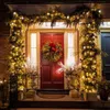 A decorated doorway for Christmas with lights and a wreath. Produktbild-Vorschau