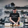 A man in a kitchen preparing food. Anteprima dell’immagine prodotto