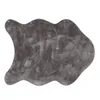 A grey, irregularly shaped rug with a textured surface, isolated on a white background. Produktbild-Vorschau