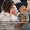 A mother is using a breast pump while holding her baby. Produktbild-Vorschau