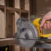 A hand is using a yellow and gray cordless circular saw to cut a wooden plank. Sawdust is flying. Produktbild-Vorschau