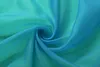 A close-up swirl of turquoise and green sheer fabric. Produktbild-Vorschau
