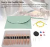 A flat lay of knitting needles, cables, and accessories, with a mint green pouch in the background. Náhľad obrázku produktu