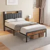 A bedroom scene featuring a bed with a headboard and storage, a nightstand, and a dresser. Voir les images du produit