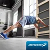A man is doing a plank exercise on a wooden wall bar in a gym. Podgląd zdjęcia produktu