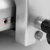 A close-up view of the side of a silver meat slicer, showing a black knob and a screw. Náhľad obrázku produktu