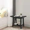 A black shower bench with a shelf is placed in a room with a window and curtains. Náhled obrázku produktu