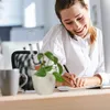 A woman working at a desk in an office. Produktbild-Vorschau