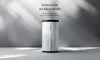 A white cylindrical air purifier is centered against a light gray background with dramatic shadows cast from the left. Produktbild-Vorschau