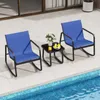 Two blue chairs and a small black table are placed on a tiled patio next to a swimming pool. Anteprima dell’immagine prodotto