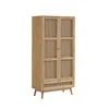 A wooden cabinet with rattan doors and a drawer, standing on four legs against a white background. Produktbild-Vorschau