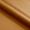 A close-up view of a folded piece of fabric with a textured surface and a slight sheen. Náhľad obrázku produktu