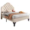 A beige upholstered bed with a tufted headboard and bedding. Náhled obrázku produktu