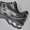 A close-up side view of a black ASICS running shoe. Produktbild-Vorschau