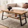 A modern living room scene with a couch, rug, and coffee table. Voir les images du produit