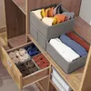 Closet organizer boxes filled with folded clothes and ties. Produktbild-Vorschau