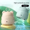 Two cartoon-styled mini vacuum cleaners are shown against a soft, abstract background with green hills and blue water. Náhled obrázku produktu