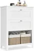 A white bathroom cabinet with two drawers and two wicker baskets on the bottom shelf. Several bathroom accessories are on top of the cabinet. Náhľad obrázku produktu