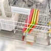 A set of four colorful cutting boards is placed in a dishwasher rack. Produktbild-Vorschau