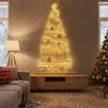 A living room decorated for Christmas with a wall-mounted wooden Christmas tree and a traditional Christmas tree. Anteprima dell’immagine prodotto