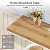 A close-up of a rustic wood sofa table with a vase of flowers on it. Anteprima dell’immagine prodotto