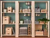 A wooden shelving unit filled with various storage boxes, jars, bottles, and plants. Náhled obrázku produktu