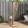 An outdoor shower in a backyard setting with a wooden fence and deck. Náhľad obrázku produktu