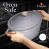 A person is placing a pot into an oven. Náhľad obrázku produktu