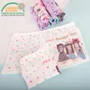 A flat lay of children's underwear with rolled up pairs in the background. Produktbild-Vorschau