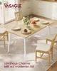 A dining table set up in a bright, modern kitchen or dining area, with chairs, plates, and a cake. Produktbild-Vorschau
