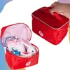 A red doctor's bag with medical toys inside, and another closed red doctor's bag being held by a hand. Anteprima dell’immagine prodotto