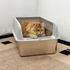 A cat is sitting in an open litter box on a patterned rug. Produktbild-Vorschau