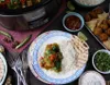 A table setting with a slow cooker and a plate of food. Náhled obrázku produktu