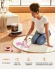 A woman is cleaning a rug with a carpet cleaner. Náhled obrázku produktu