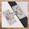 Two metal hinge repair plates are shown attached to wooden surfaces, with one plate connected to a black strip. Náhľad obrázku produktu