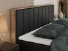 A close-up view of a bed with a black upholstered headboard and a wooden frame. Produktbild-Vorschau