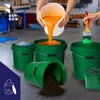 A scene showing several green buckets, one being filled with orange liquid, another with green paint being applied by a brush, and one overturned with soil spilling out. A small bucket of screws is also visible. Podgląd zdjęcia produktu