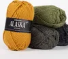 Several balls of yarn are stacked, with one in the foreground showing a label. Produktbild-Vorschau