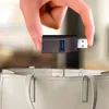 A hand holding a USB hub over a handbag. Anteprima dell’immagine prodotto