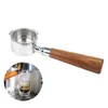A portafilter with a wooden handle, shown in isolation and with a close-up inset of it being used to brew espresso into a shot glass. Podgląd zdjęcia produktu