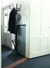 A coat rack with a coat and hat is standing in a hallway next to a white door. Anteprima dell’immagine prodotto