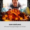 A man is looking into an oven at a roasted chicken with potatoes. Produktbild-Vorschau