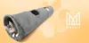 A kitten playing in a gray cat tunnel with holes, on an orange and yellow gradient background with paw print graphics. Produktbild-Vorschau